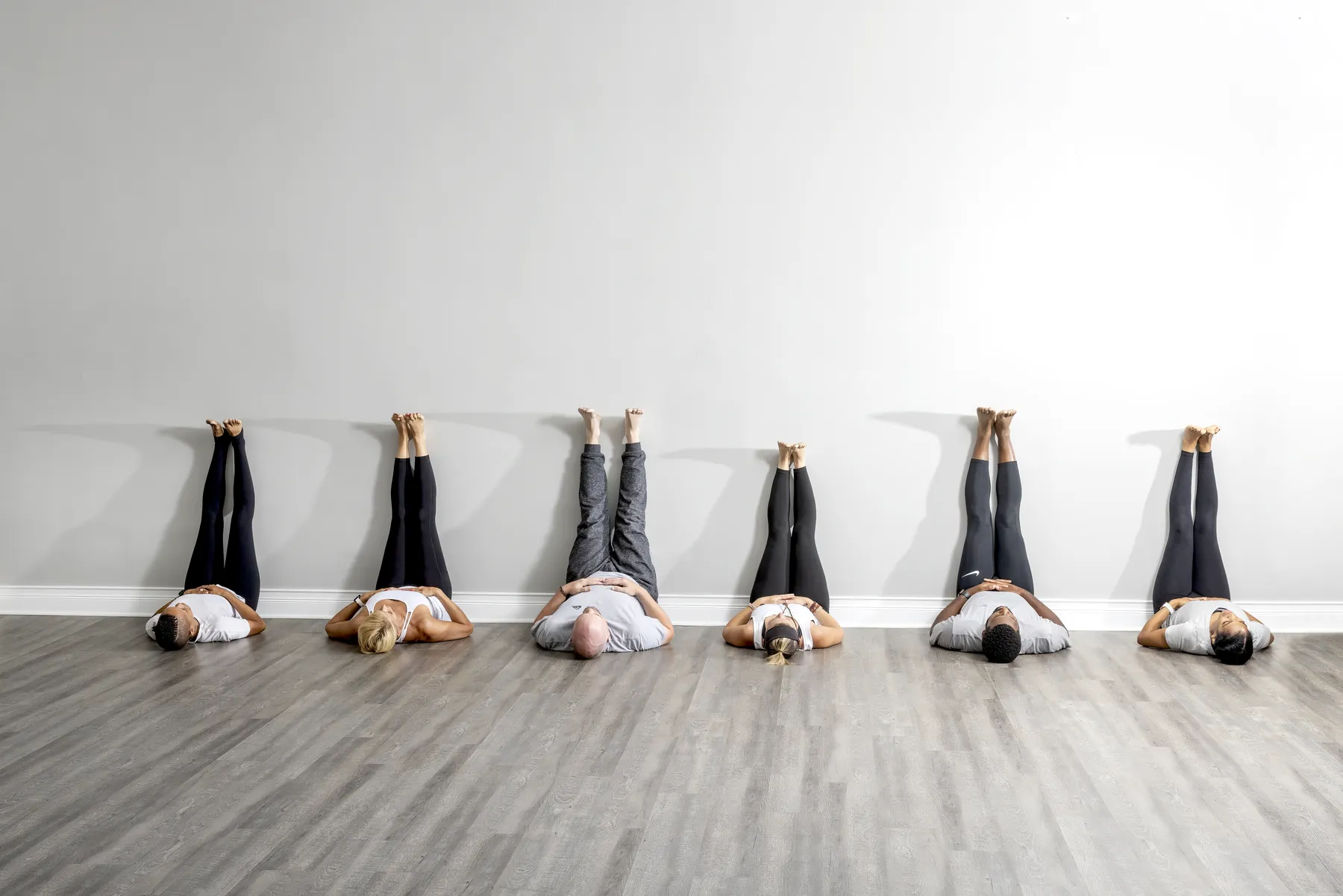 Students resting in legs-up-the-wall during a gentle class