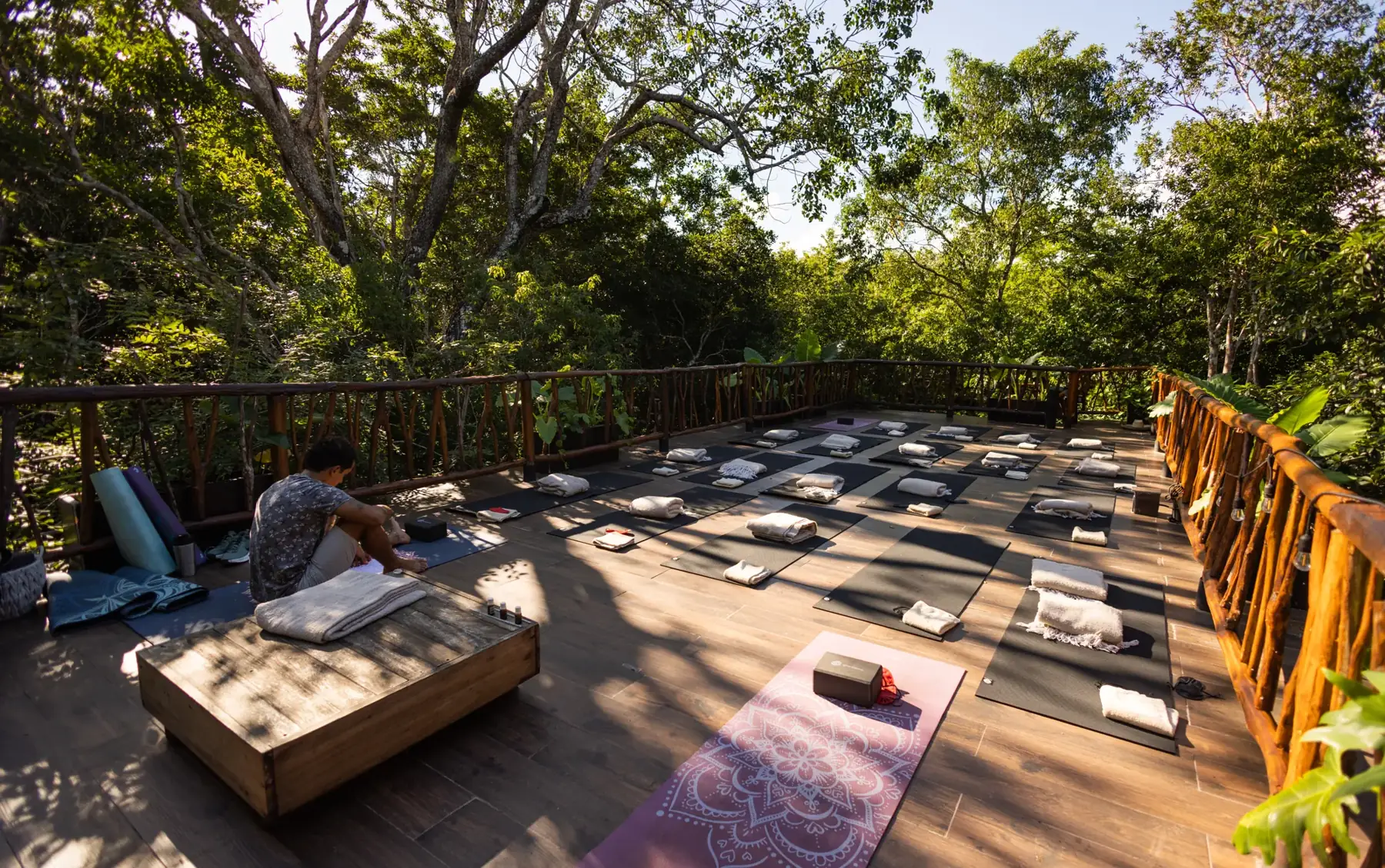 Yoga mats set out on Kaaba Luum's open-air deck in the jungle outside Tulum